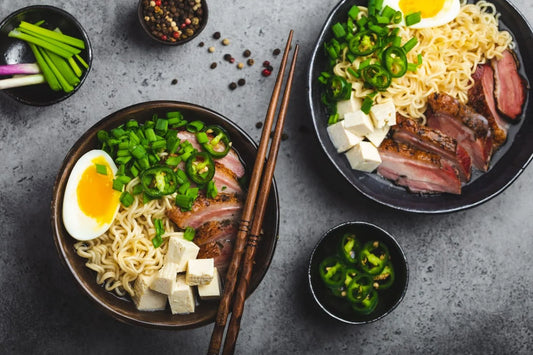 Ramen soup with a soft-boiled egg, green onions, jalapeños, tofu, and grilled pork, garnished with fresh vegetables, perfect for a comforting meal. Explore which vegetables are best for ramen soup