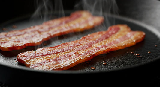 Close-up of crispy bacon sizzling in a frying pan