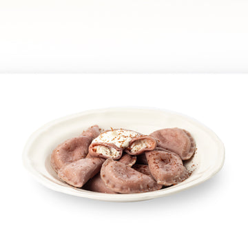 Vareniki "Stracciatella" on cherry juice with quark-chocolate filling